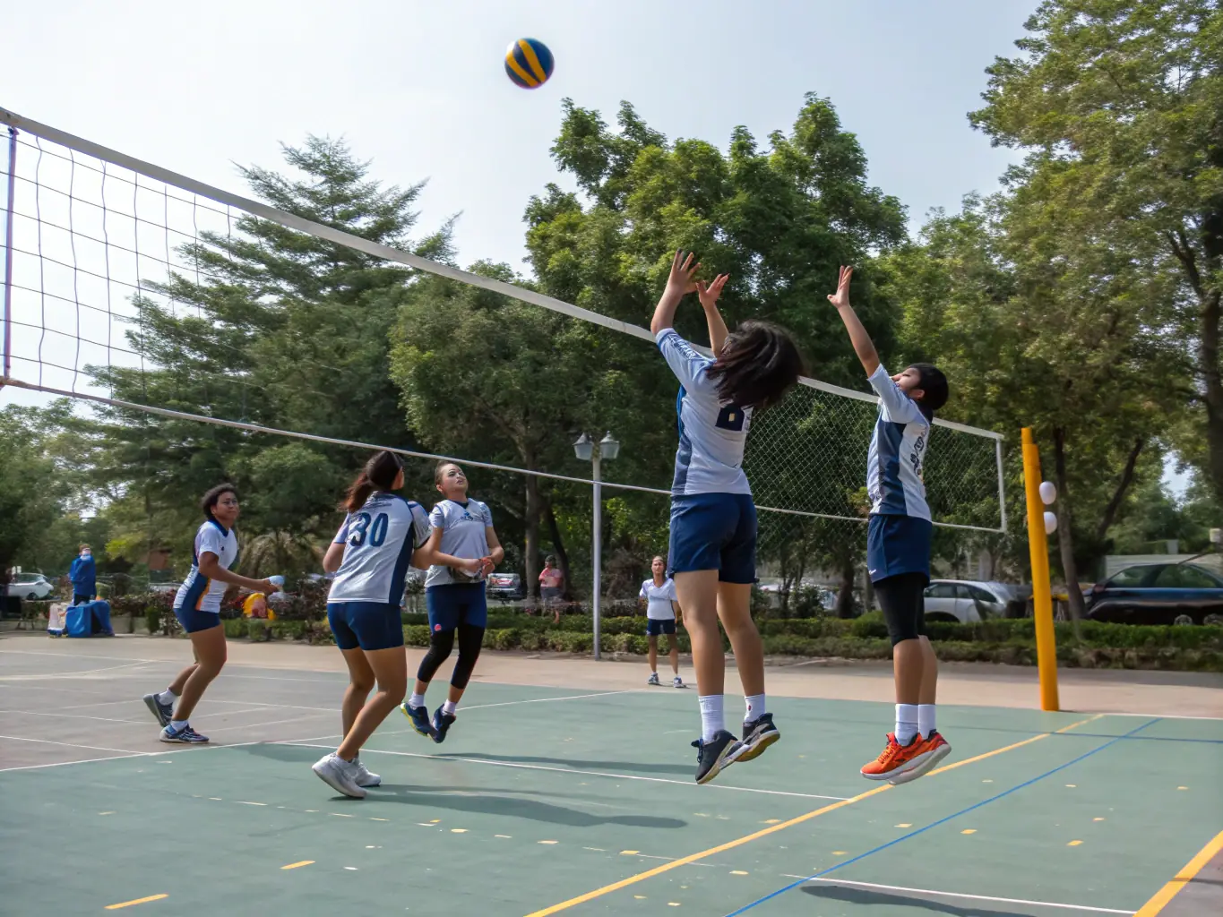 A dynamic scene of a team sports activity, such as basketball or volleyball, with participants actively engaged and demonstrating teamwork.